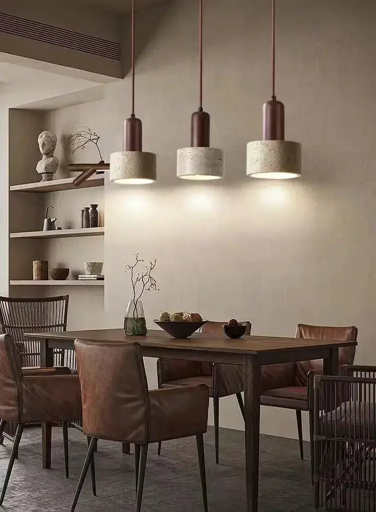 Simples Market travertine pendant lights, three yellow marble droplights over a wooden dining table
