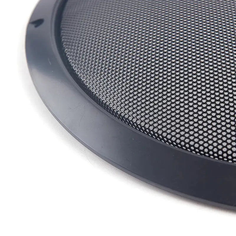 Round speaker grille with dark gray metal mesh and plastic frame