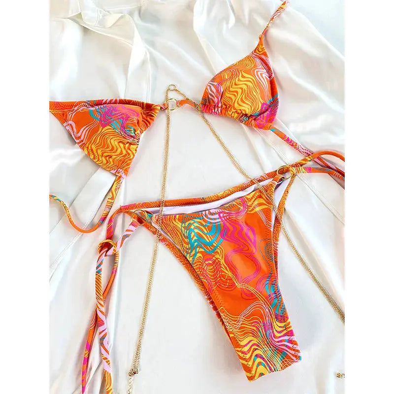 Two-piece sexy triangle bikini set with chain accents in orange multicolor print; thong bottoms