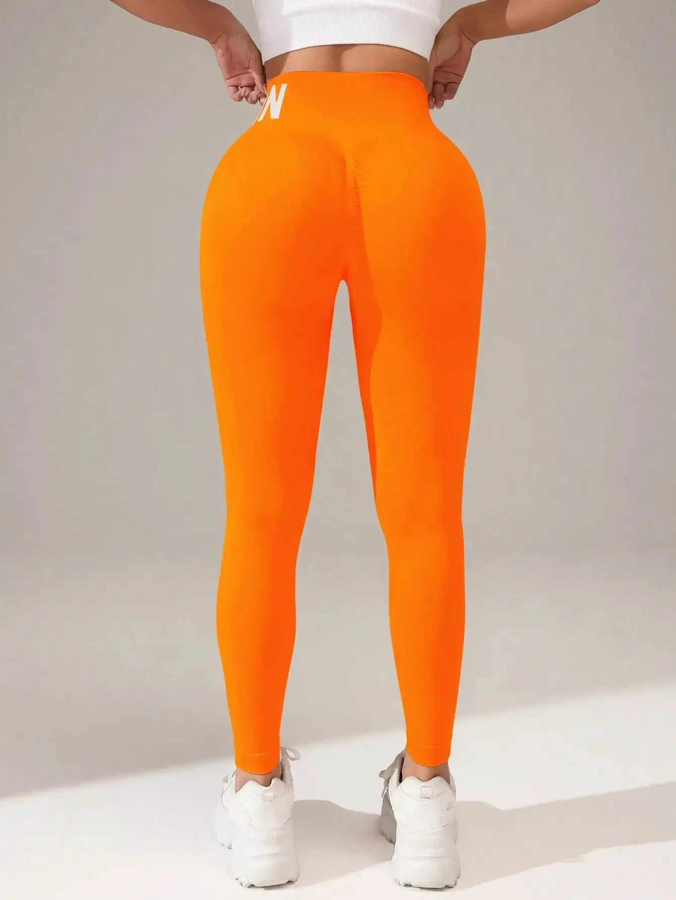 Seamless yoga leggings in bright orange with a high waistband, butt-lifting, quick-dry breathable tights back view