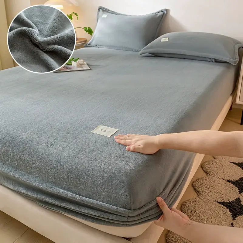 Velvet thermal mattress cover on bed; plush gray-blue fabric, 120x200 cm