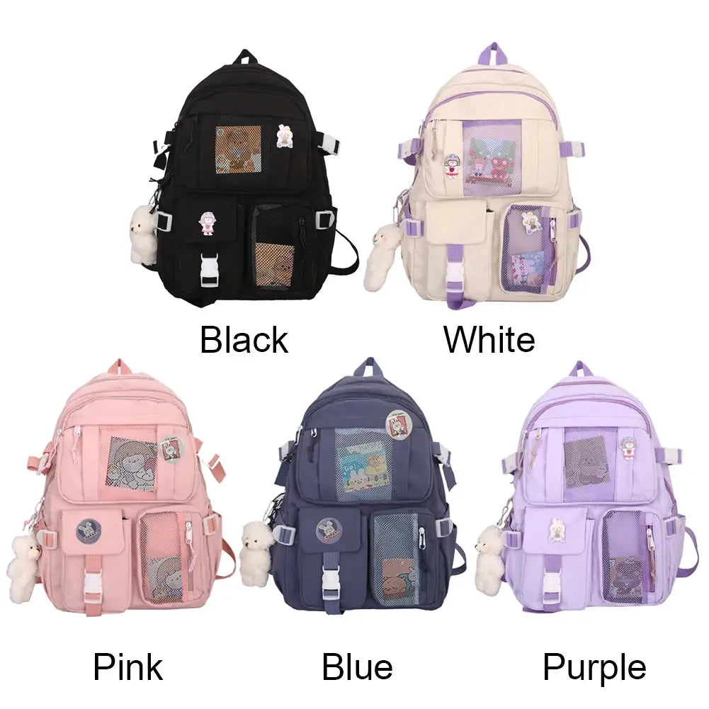 Five Simples Market school backpacks in black, white, pink, blue, and purple with mesh pockets and plush keychains