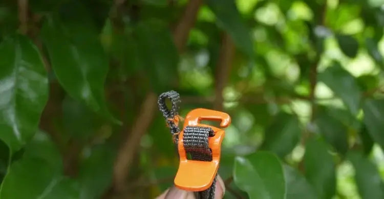 Camping luggage strap with orange quick-release buckle and black woven strap