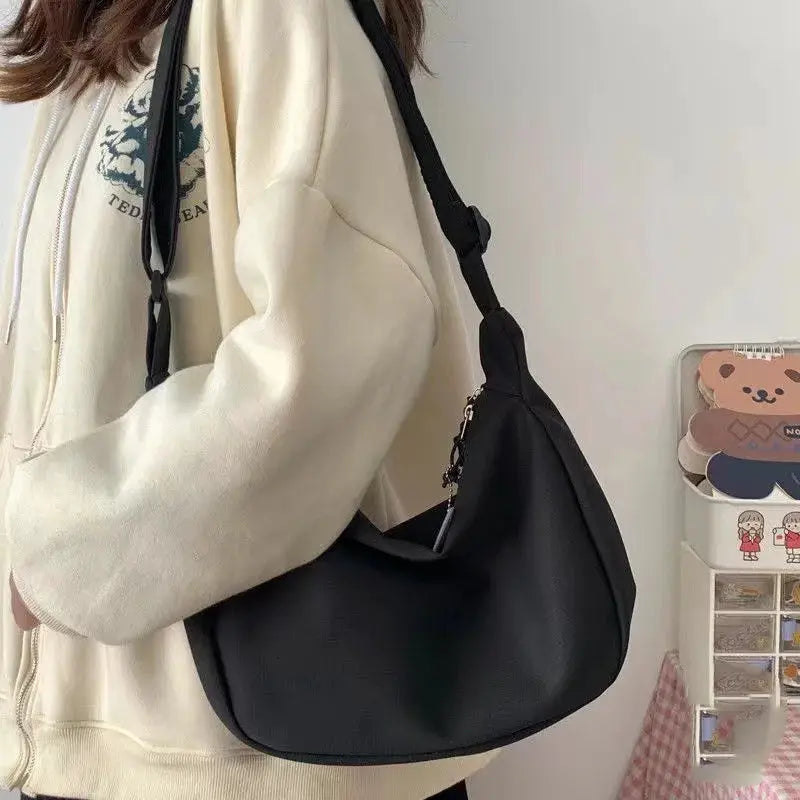 Black faux-leather shoulder bag with long strap; large-capacity, simple crossbody purse for women