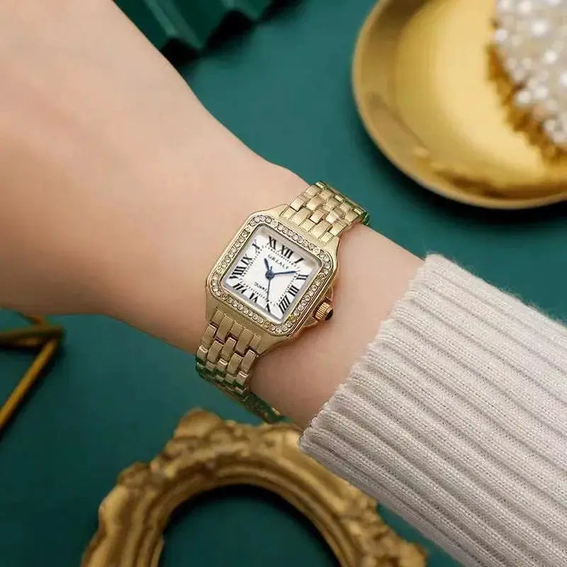 Gold-toned square rhinestone women's quartz watch by Simples Market on wrist