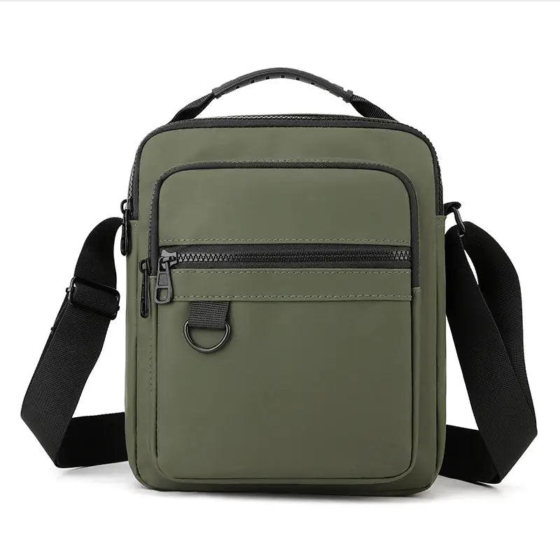 Messenger sling bag by Simples Market in olive green with front zip pocket and adjustable strap.