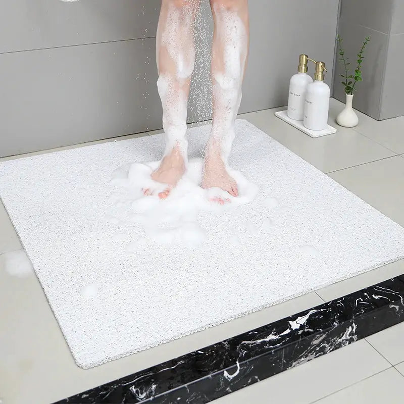 Grey non-slip hollow bath mat for bathroom with foot-massage texture; quick-drying shower mat for bath, hotel & floor.