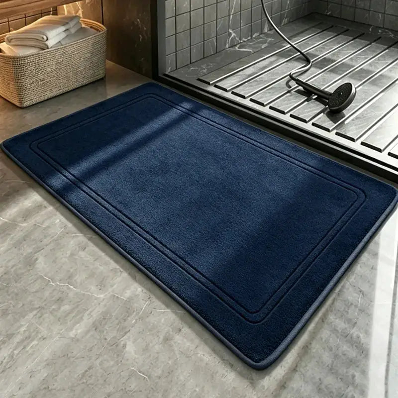 Bathroom rug, blue for shower area; mat on tiled floor