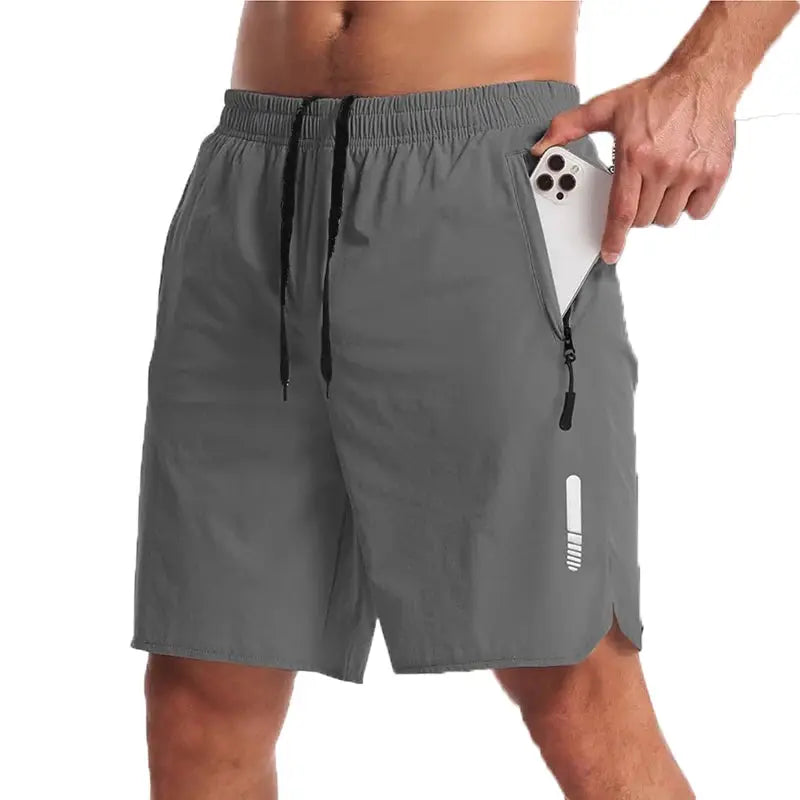 Men's grey sport shorts with drawstring waist, side zip pocket holding a phone, reflective stripe