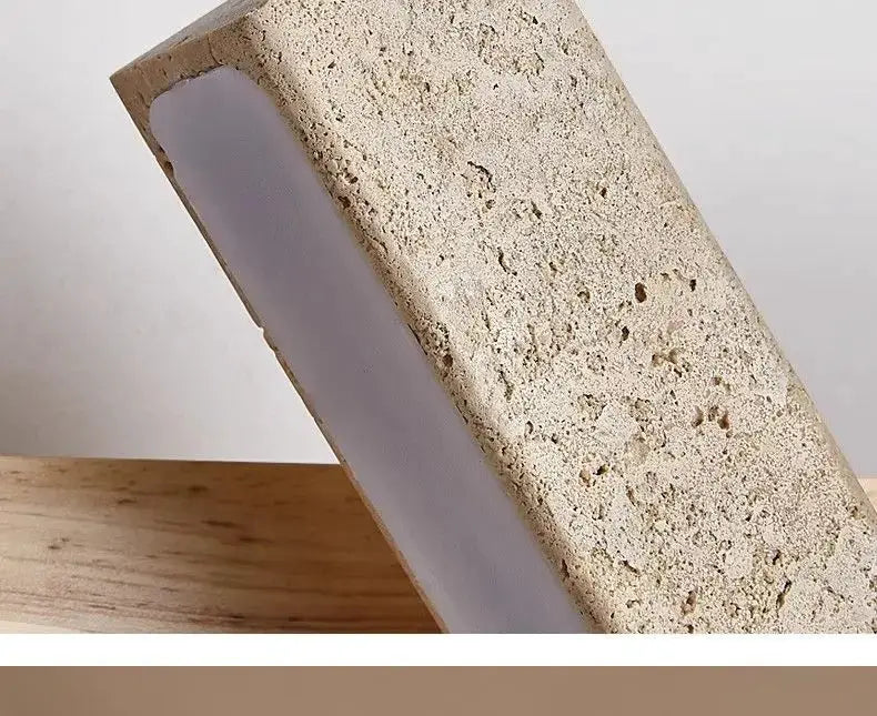Natural stone wall lamp sconce with beige textured exterior and white interior panel
