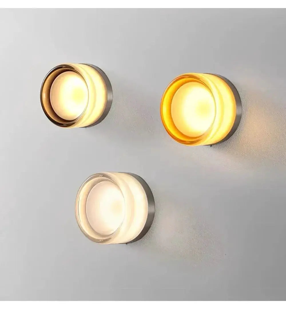 Modern LED wall lamp trio; amber glow with frosted glass on smoky grey fixtures