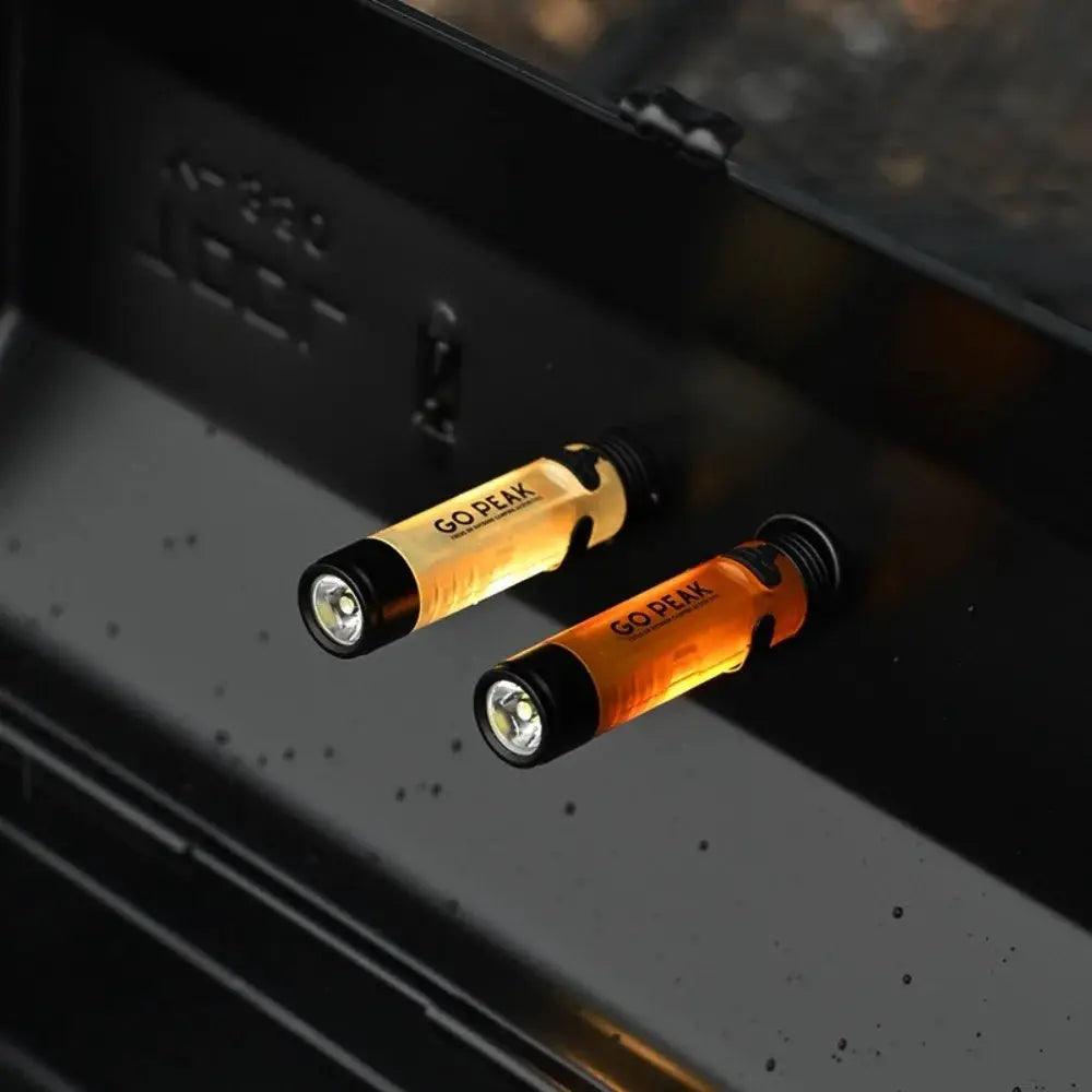 Two Go Peak mini pocket LED flashlights with clip keychain, USB rechargeable, orange and gold bodies