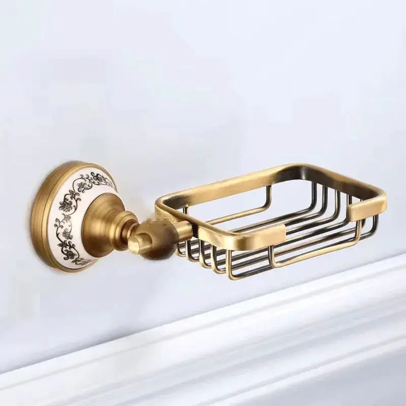 Simples Market antique brushed brass wall-mounted soap basket with porcelain decorative backplate.