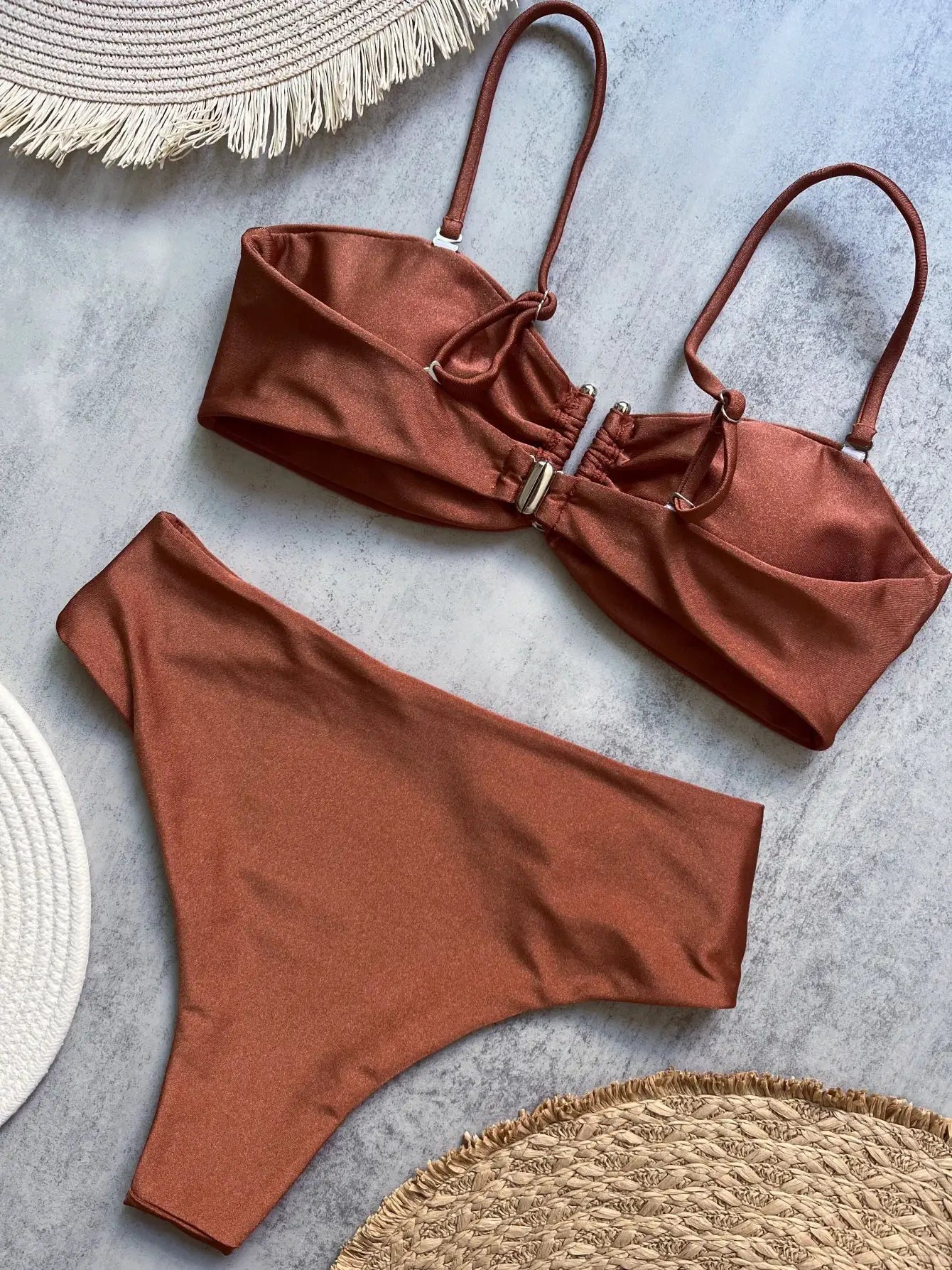 Bandeau bikini set in rust color with adjustable straps and metal clasp; solid women’s swimwear