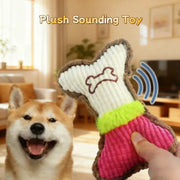Plush dog bone squeaky chew toy with white ribbed center, brown border, neon green trim and pink body