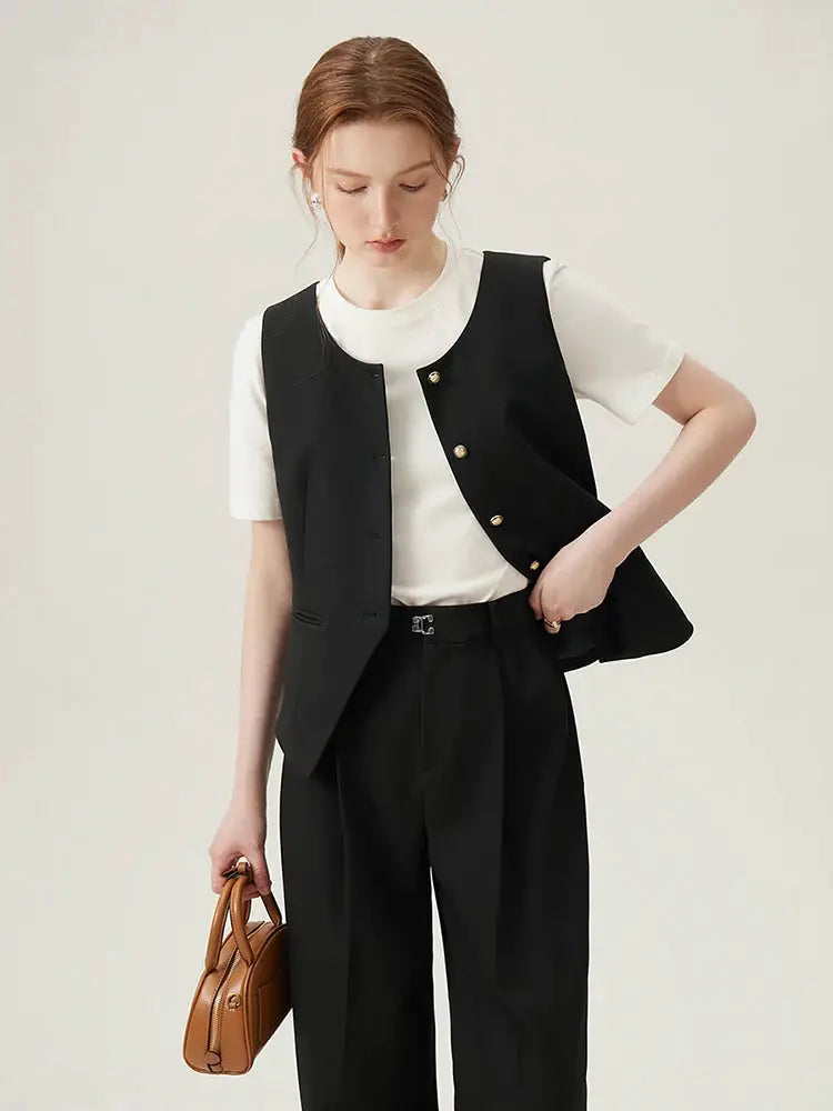 FSLE women's black blazer vest set with gold buttons over white tee and black pants; model carries a brown handbag.