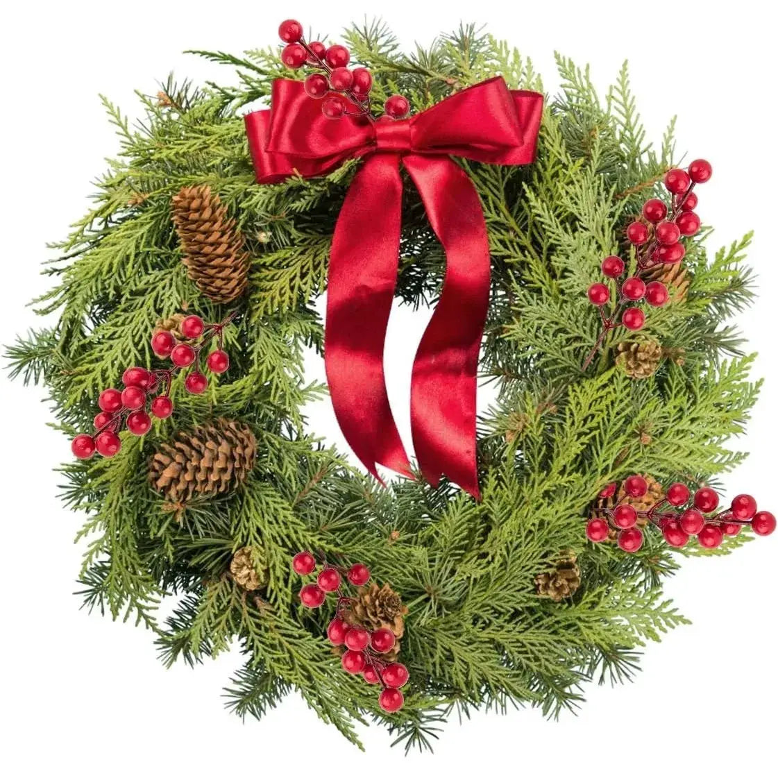 Christmas wreath by Simples Market; artificial pine branches with red berries, pinecones, and a red ribbon bow