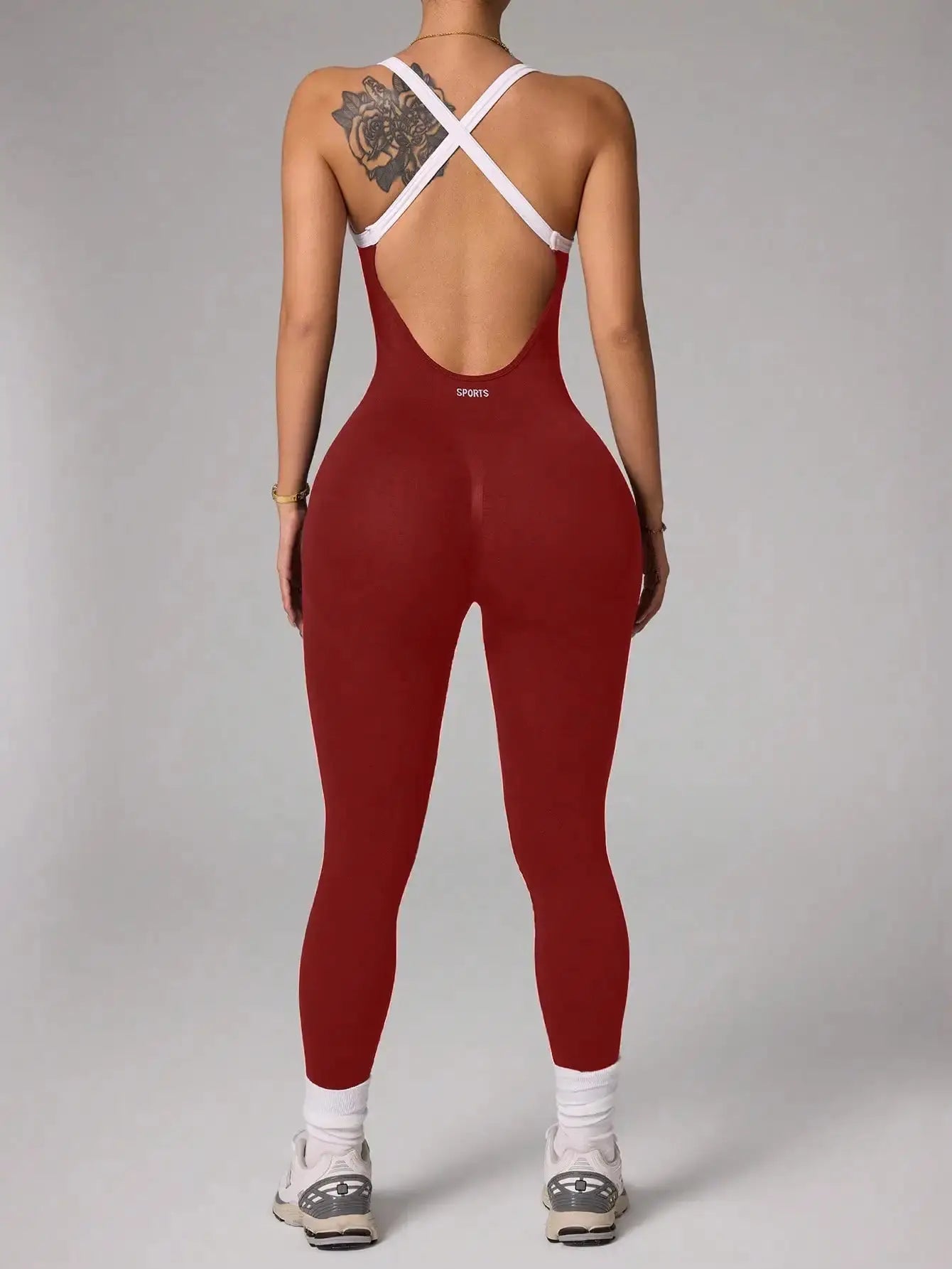 Cross-shoulder strap red seamless open-back yoga jumpsuit with white crisscross straps