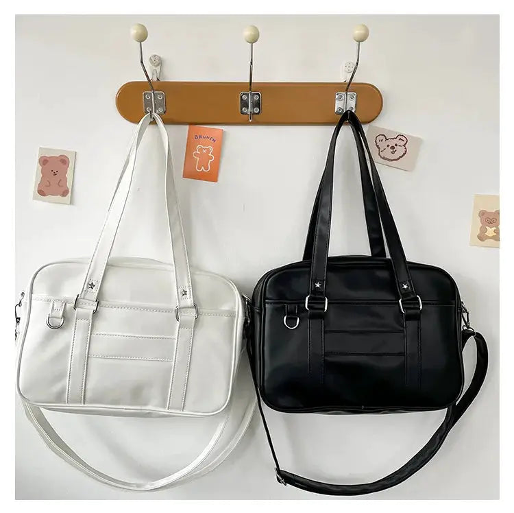 Two PU leather Japanese style JK bags for women in white and black with top handles and crossbody straps