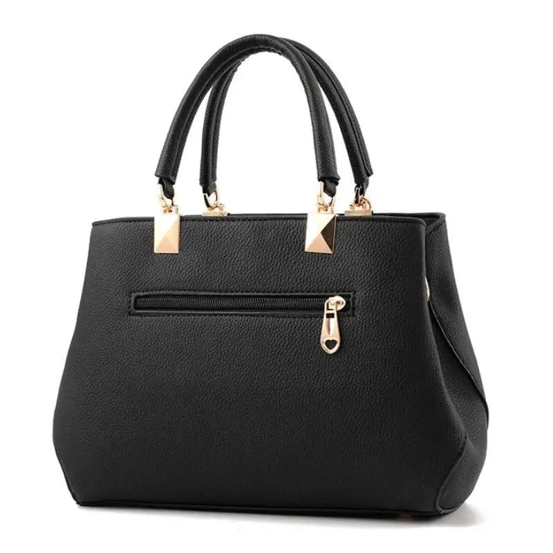Women handbag by Simples Market black textured leather with gold hardware and dual top handles