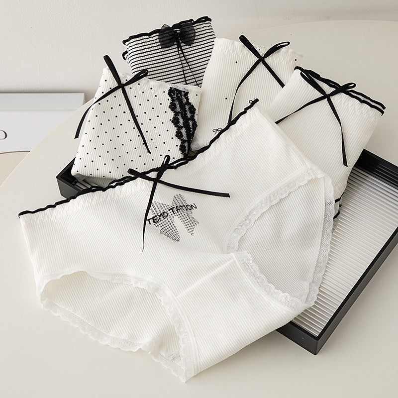 Six white ribbed panties with lace trim and black bow accents, displayed together
