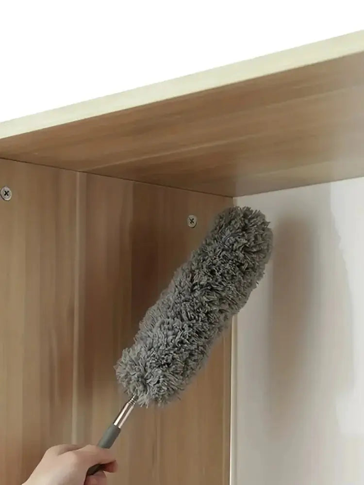 Hand-held dusting duster with gray microfiber head and metal handle for cleaning cabinet interiors