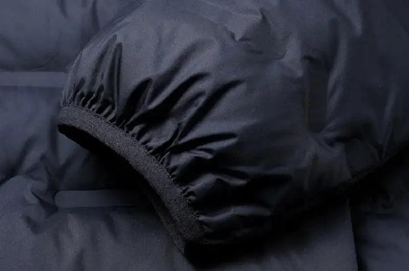 Men's black duck-down puffer jacket cuff close-up with elastic sleeve