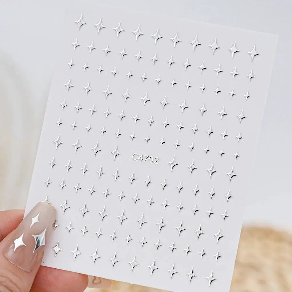 Metal silver nail sticker sheet featuring 3D star decals; self-adhesive, small star shapes.