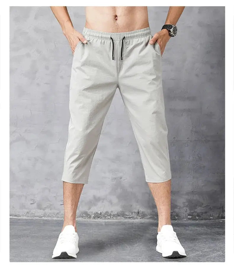Men's 3/4 length quick-dry nylon shorts in light gray with a drawstring waist.