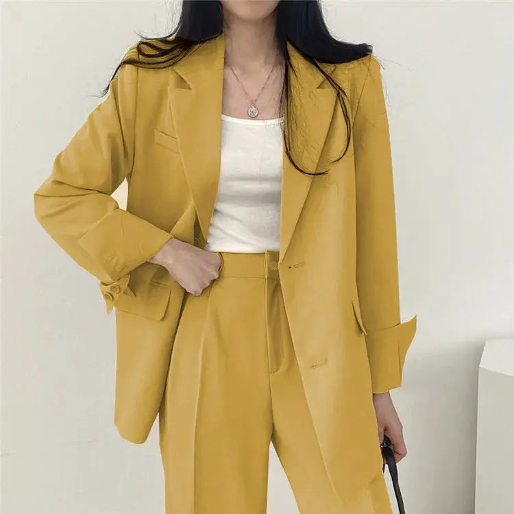 Two-piece blazer and pants suit for women in mustard yellow with a white top.