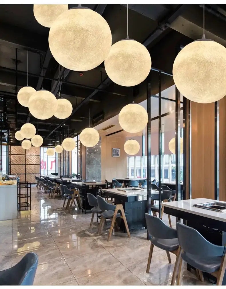 Nordic Moon LED pendant lights by Simples Market; warm white glass spheres hanging over a modern restaurant dining area