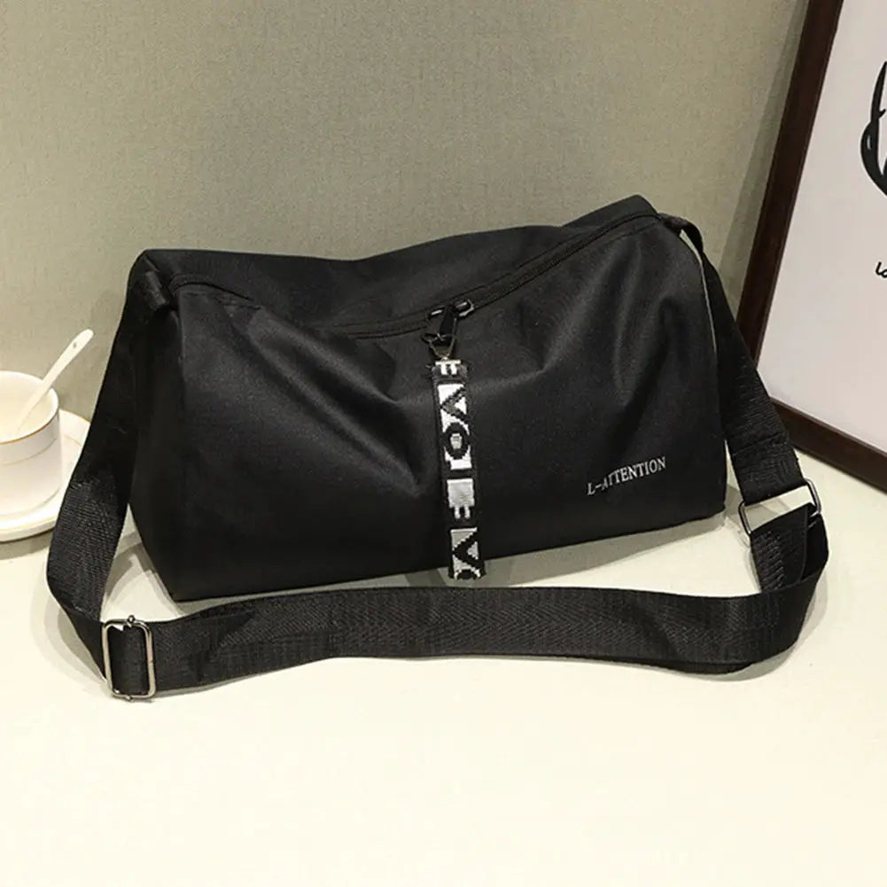 Sport gym bag in black with adjustable shoulder strap and top zipper closure