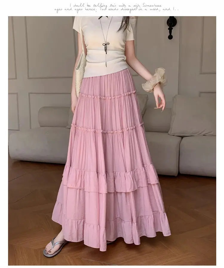 Pink tiered maxi skirt with ruffle-hem layers; high-waist, flowy chiffon.