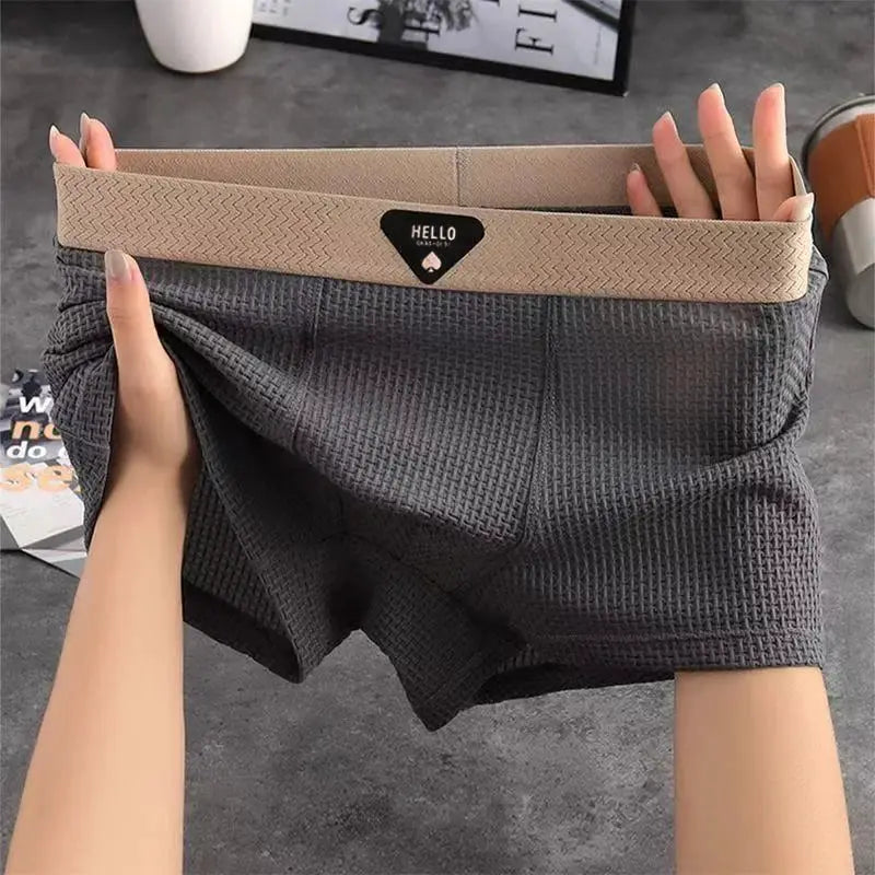 Men's boxer shorts in charcoal waffle-knit fabric with a tan elastic waistband and Hello logo patch