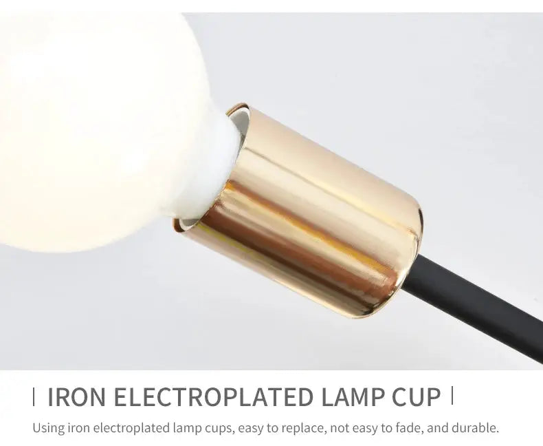 Copper-finish iron lamp cup with LED bulb on a black cord lamp fixture.
