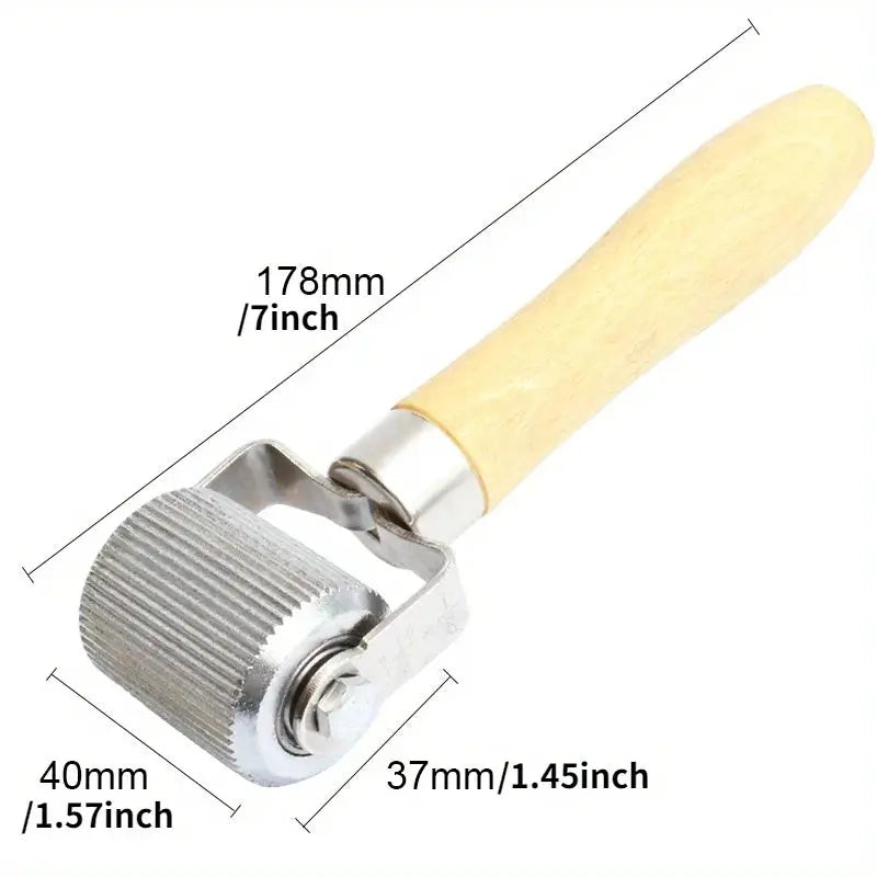 Car tire repair roller with wooden handle and metal head for wheel repairs.