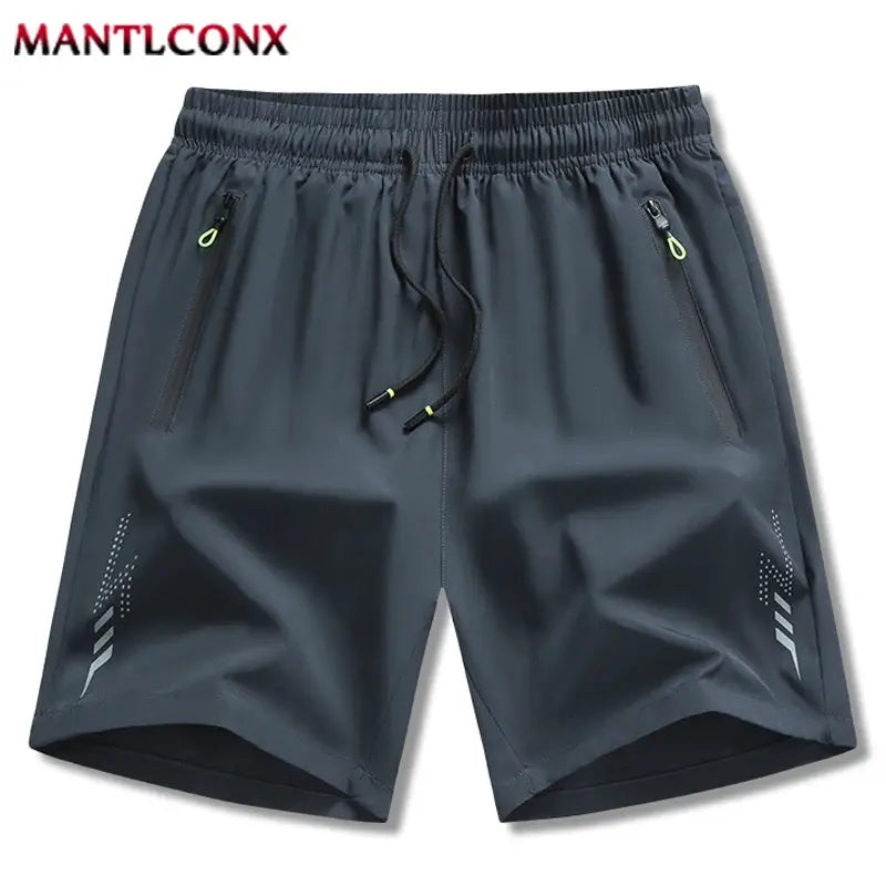 MANTLCONX men's shorts in dark gray with drawstring waist, zip pockets, neon zipper pulls, breathable quick-dry fabric