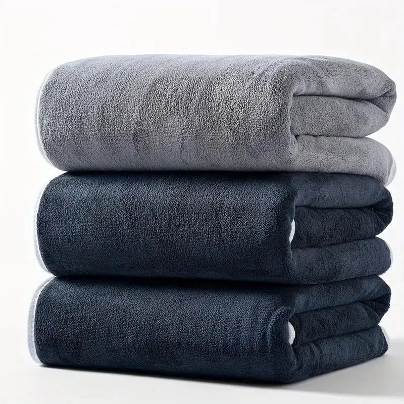 3-piece large bath towel set in grey tones; plush, absorbent towels stacked