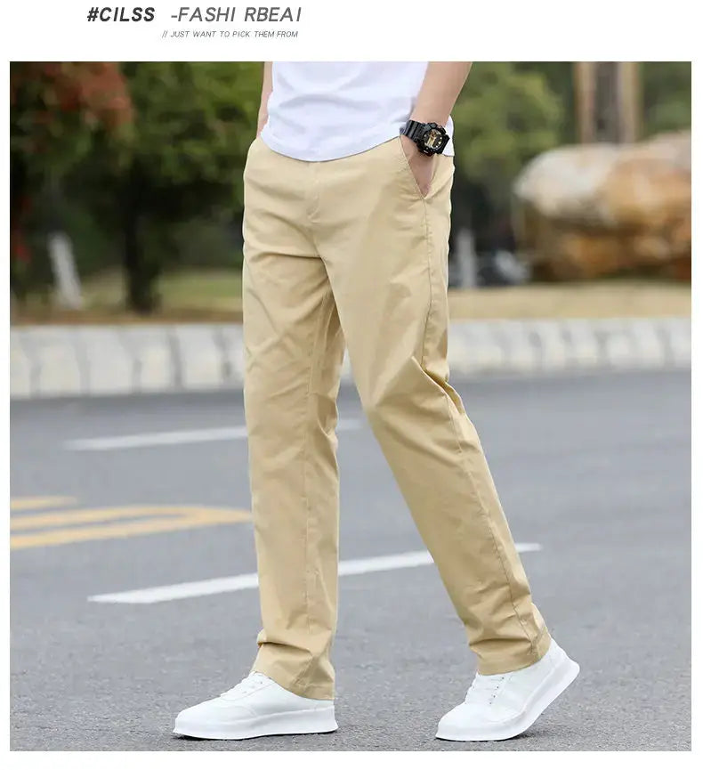 Men's beige cotton chinos with breathable straight fit, shown with white sneakers