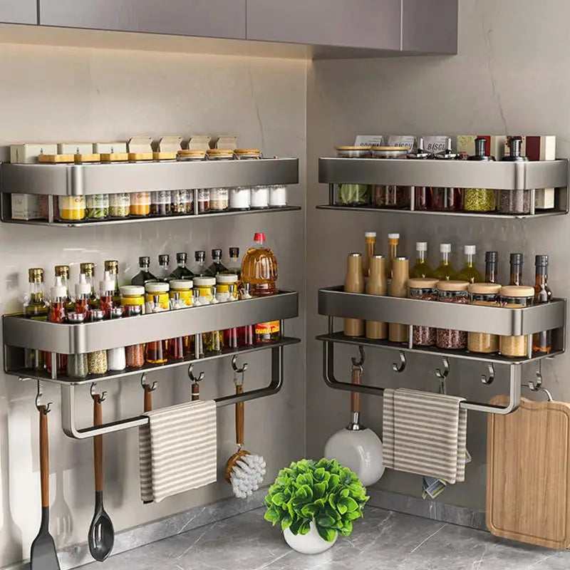 Two aluminum wall-mounted kitchen racks with stacked shelves and hanging hooks for utensils and towels