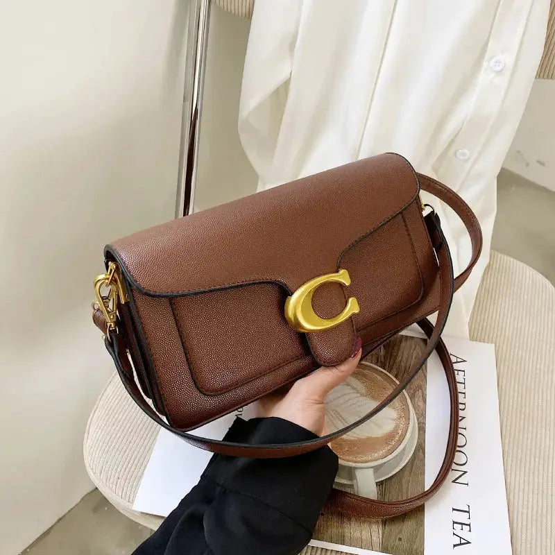 Double-Strap Small Square Crossbody Bag by Simples Market; brown pebbled leather with gold-tone C clasp.