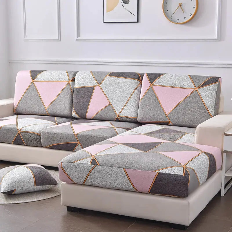 L-shaped sofa slipcover set with pink-gray geometric print covers for seats and backrests.