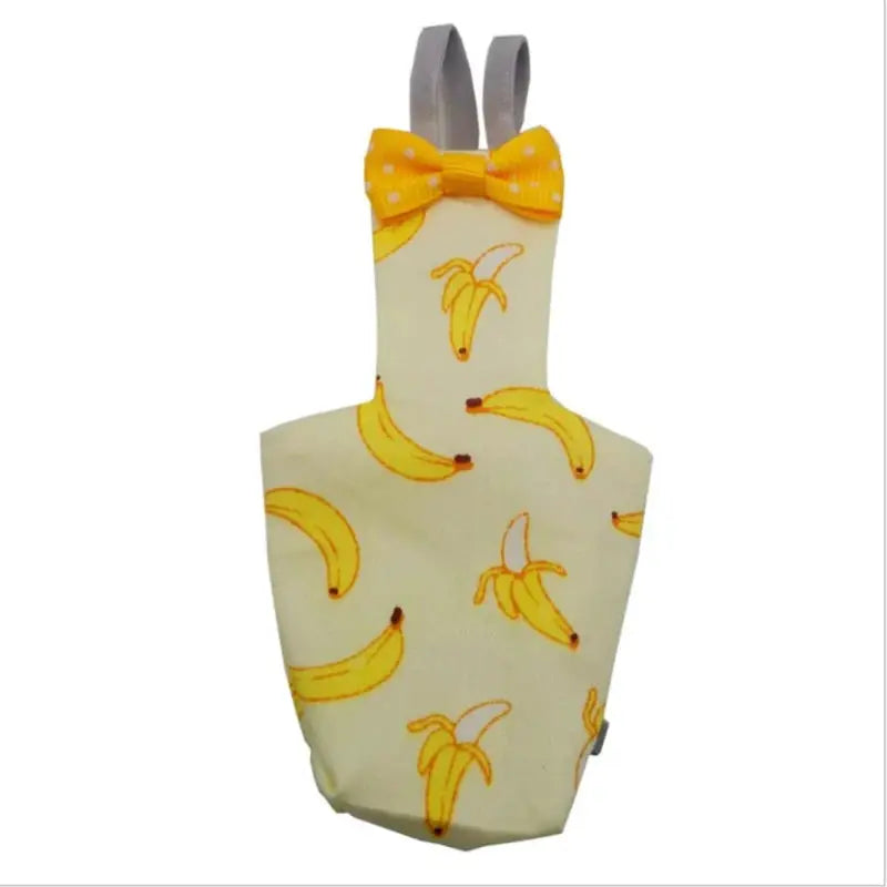 Parrot diaper with bowtie; cream fabric with banana print and gray straps.