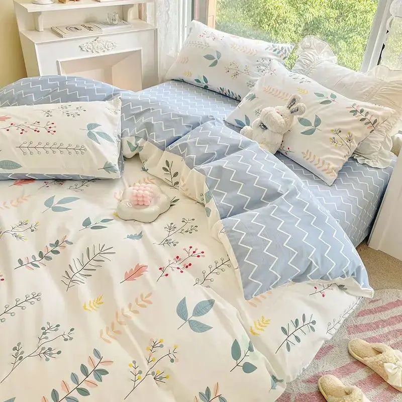 Pink floral queen bedding set with white botanical print and blue chevron reverse; includes duvet cover and pillowcases.