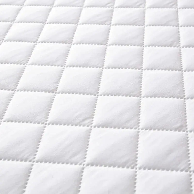 Quilted cotton pillowcase, white with a square grid pattern.