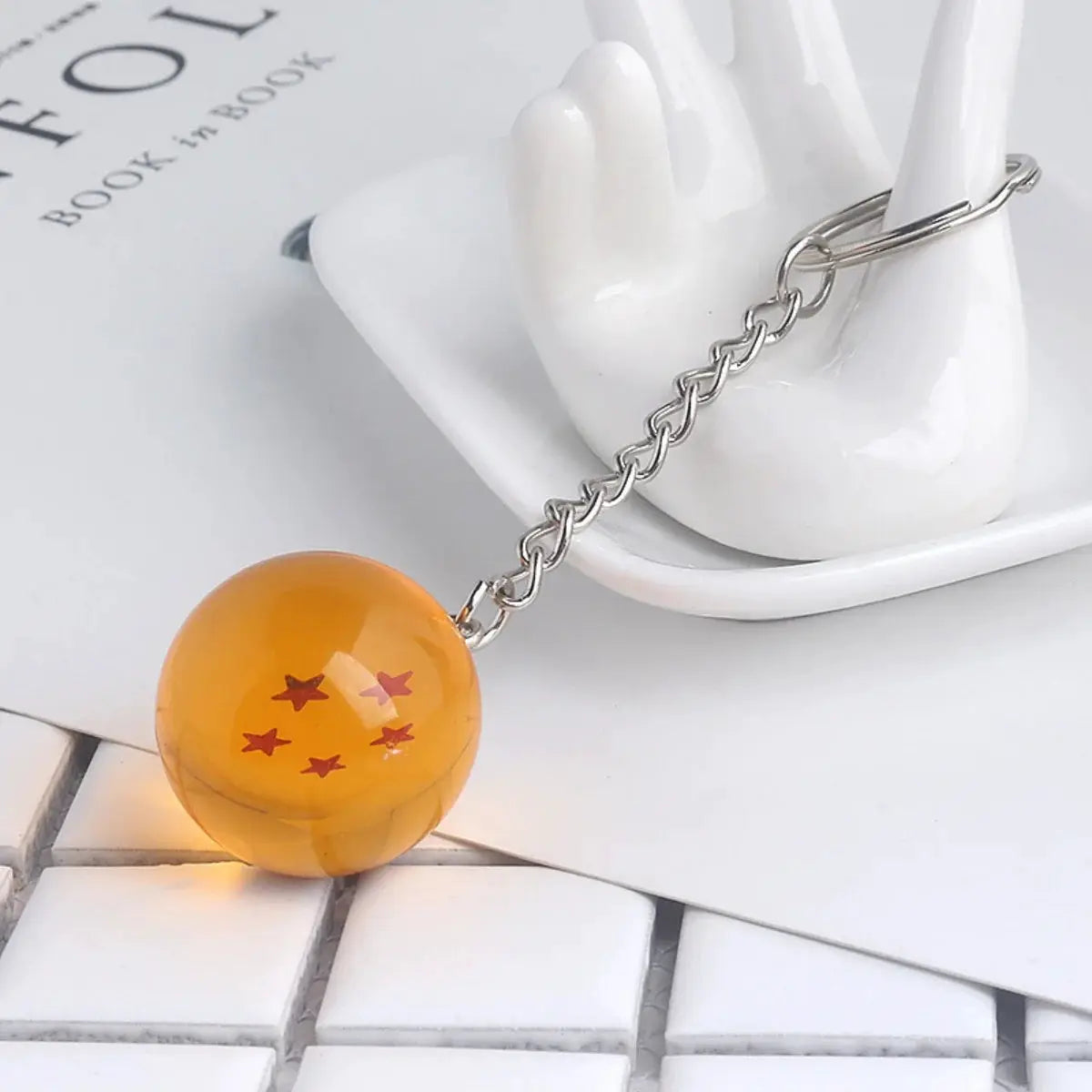 Dragon Ball keychain with orange translucent bead featuring red stars on a silver chain