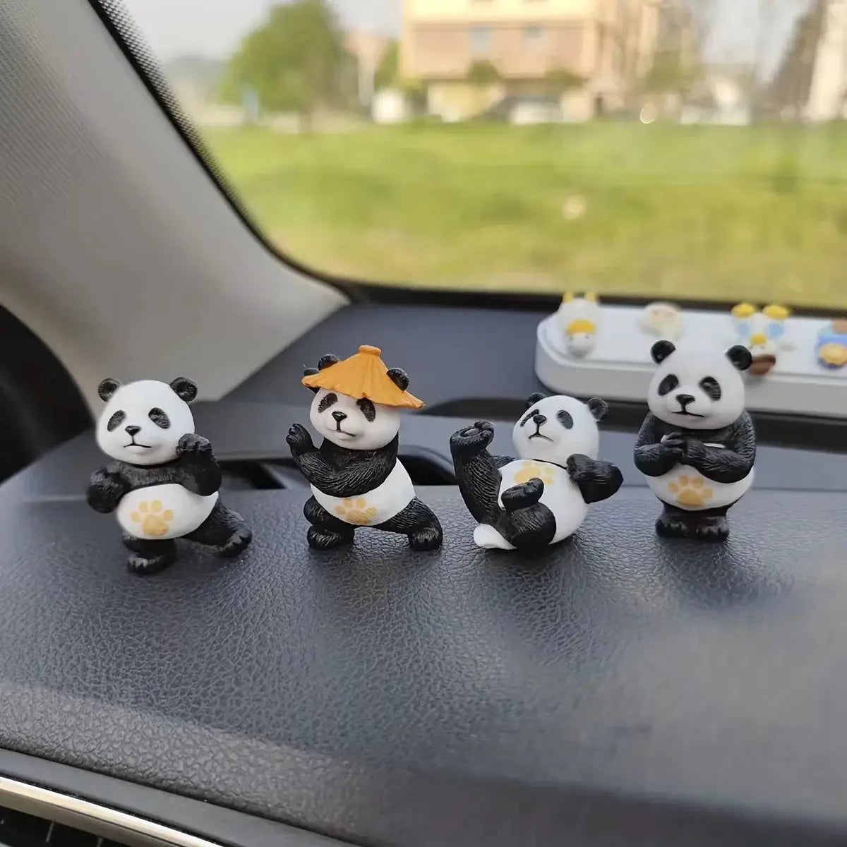 4-piece panda car ornaments for dashboard; Simples Market panda figures with yellow paw prints, one with an orange hat.