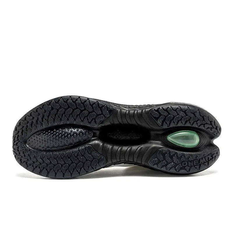 ONEMIX running shoe outsole in black rubber with green air-cushion window and rugged tread.