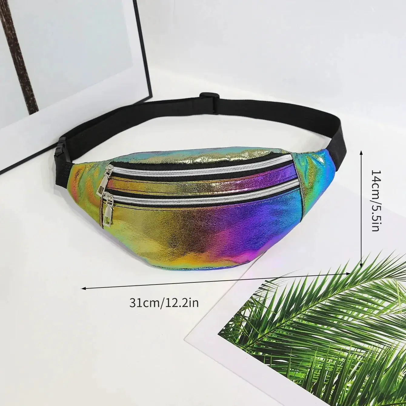 Holographic waist bag with rainbow metallic finish, 31 cm wide, two zip compartments and a black adjustable strap