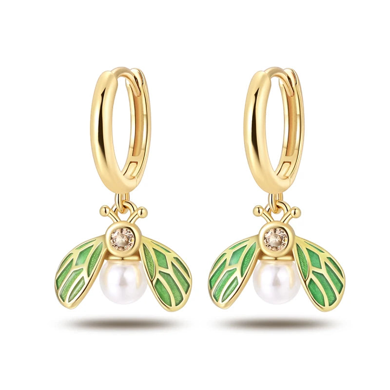 Simples Market golden hoop earrings pair with bee charms, green enamel leaves, and pearl drops